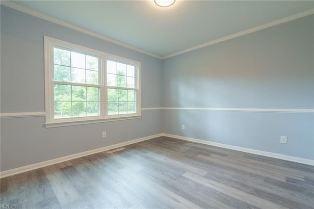 spare room with hardwood / wood-style floors and ornamental molding