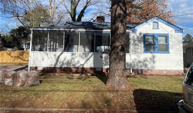 exterior space with a sunroom and a yard