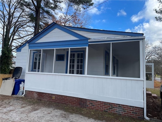 view of home's exterior featuring a sunroom