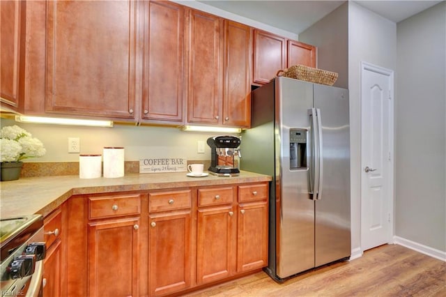 kitchen featuring appliances with stainless steel finishes and light hardwood / wood-style floors