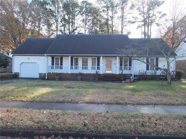 single story home with a garage and a front lawn