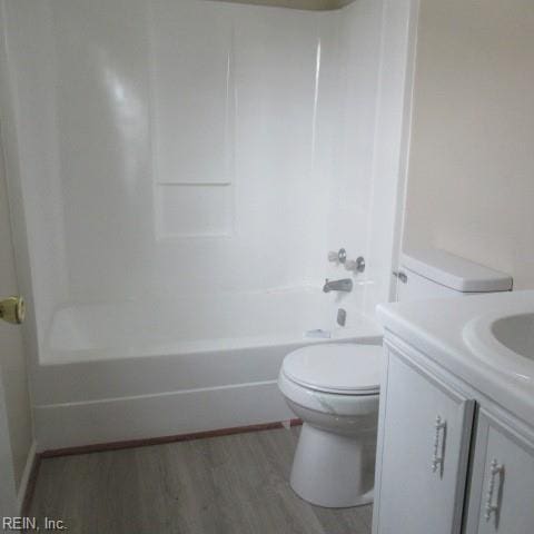 full bathroom featuring toilet, vanity, tub / shower combination, and hardwood / wood-style flooring