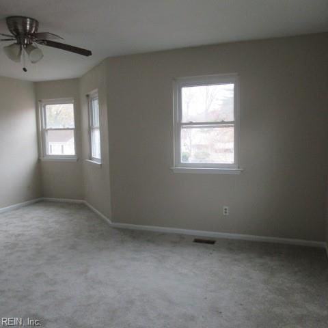 spare room featuring carpet and ceiling fan