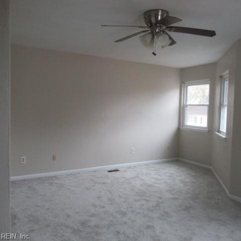 carpeted empty room featuring ceiling fan