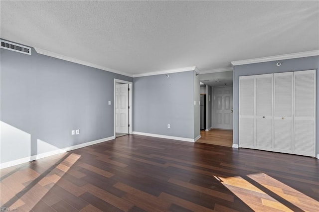 interior space with crown molding, dark wood-type flooring, and a textured ceiling