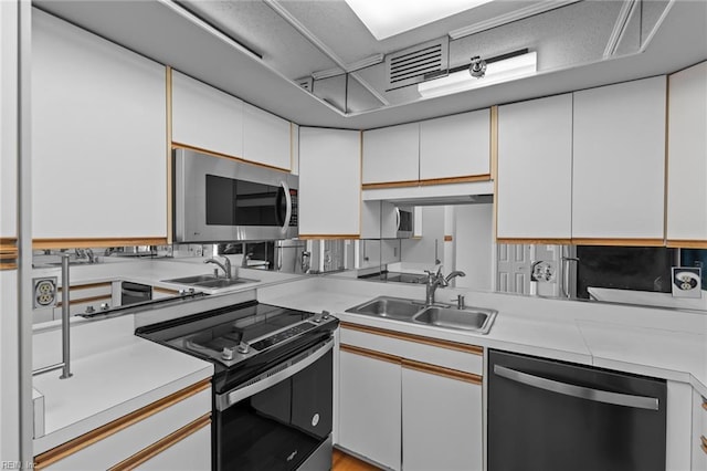 kitchen with white cabinets, sink, and appliances with stainless steel finishes