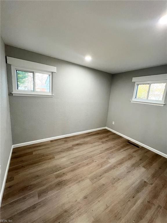 unfurnished room with wood-type flooring