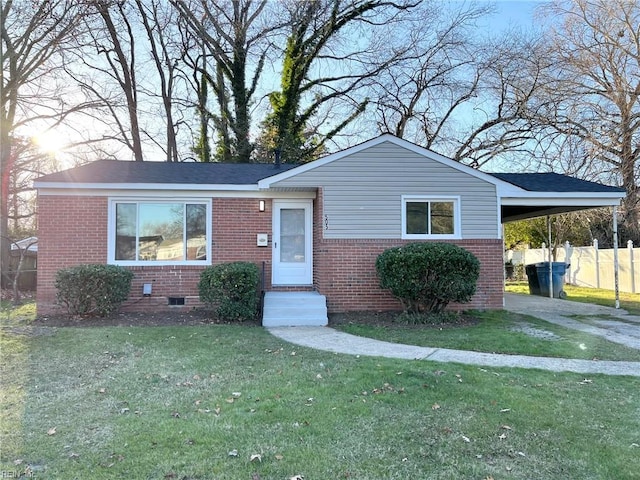 view of front of home with a carport and a front lawn