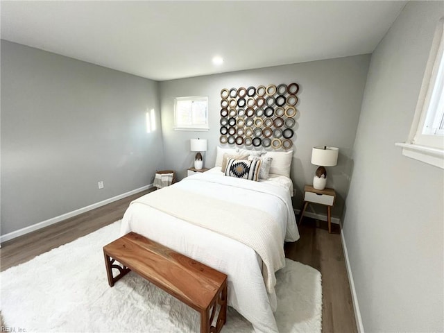 bedroom with dark hardwood / wood-style floors