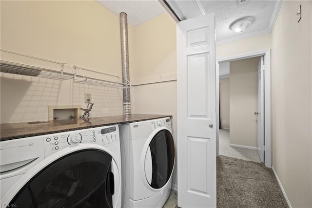 laundry room with carpet flooring, crown molding, washer and dryer, and a textured ceiling