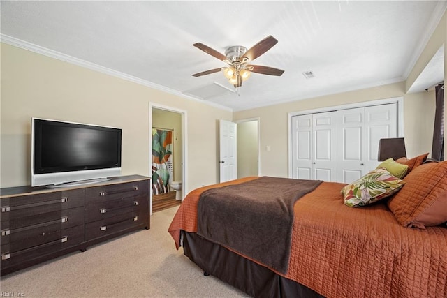 carpeted bedroom featuring ceiling fan, ensuite bath, ornamental molding, and a closet