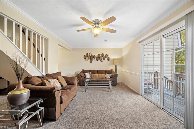 living room with carpet, ceiling fan, and ornamental molding