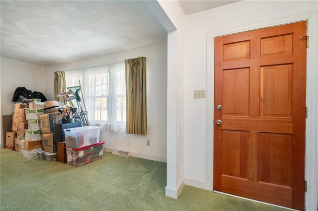 foyer with carpet flooring