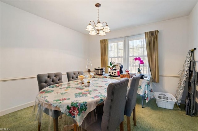 dining area with carpet and an inviting chandelier