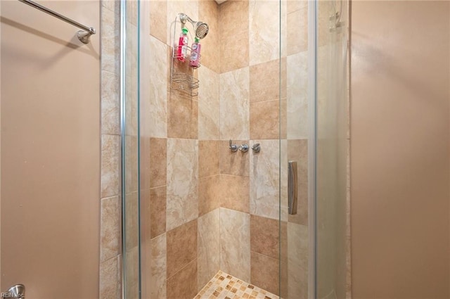 bathroom with a shower with door