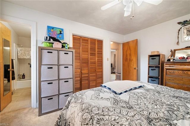 bedroom with ceiling fan, light colored carpet, connected bathroom, and a closet