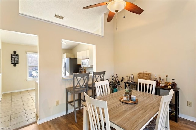 dining room with hardwood / wood-style floors and ceiling fan