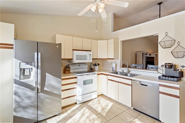 kitchen featuring ceiling fan, sink, high vaulted ceiling, light tile patterned floors, and appliances with stainless steel finishes