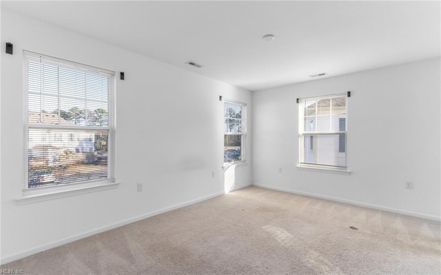 empty room featuring light carpet