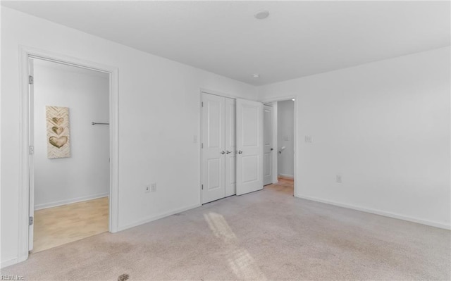 unfurnished bedroom with light carpet