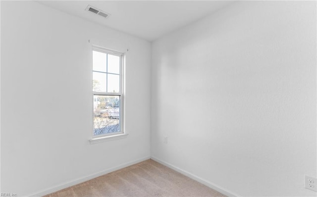 carpeted empty room featuring plenty of natural light