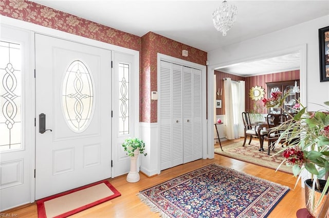 entryway featuring a chandelier and wood-type flooring