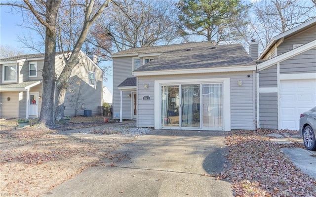 view of property with a garage and central AC