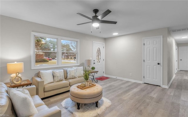 living room with ceiling fan and light hardwood / wood-style floors