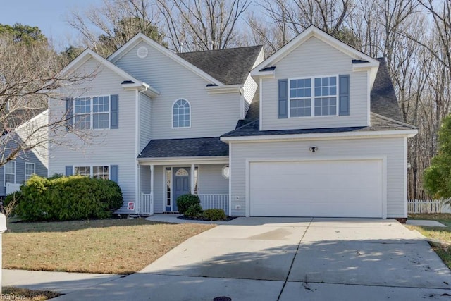 front of property featuring a front lawn and a garage