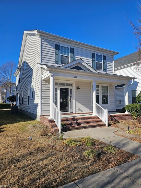 view of front of property with a porch and a front lawn