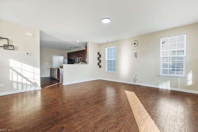 unfurnished living room featuring dark wood-type flooring