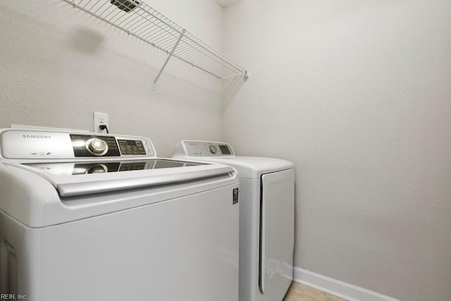 washroom featuring washer and clothes dryer