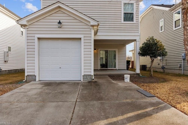 view of front of property featuring a garage and central air condition unit