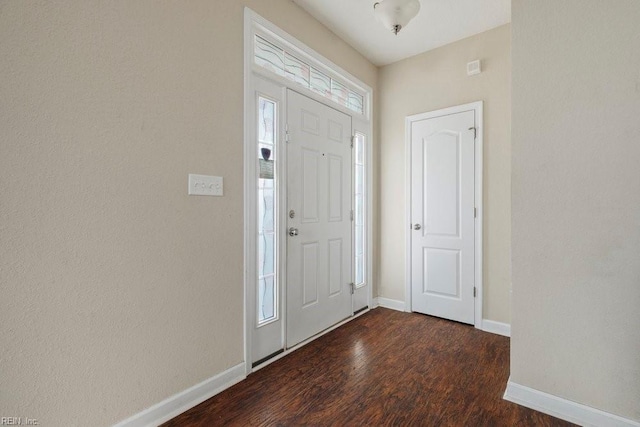 entryway with dark hardwood / wood-style flooring