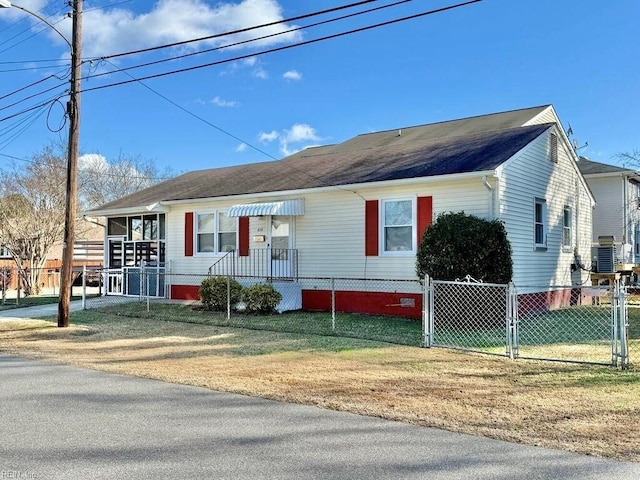 view of front of property with a front yard and central AC unit