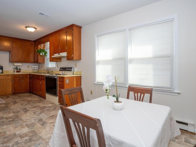 kitchen featuring electric stove, sink, and a baseboard heating unit