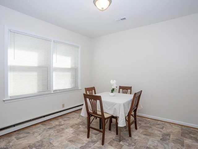 dining space featuring baseboard heating