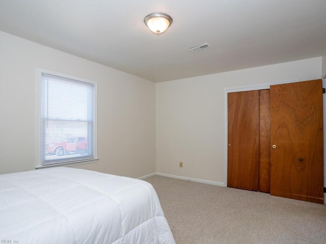 carpeted bedroom featuring a closet