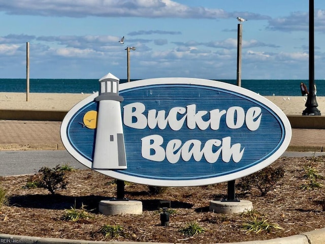 community sign with a water view