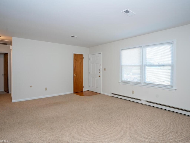 carpeted spare room featuring a baseboard radiator