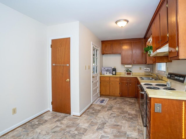 kitchen featuring range with electric stovetop and sink