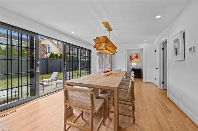 dining area with light hardwood / wood-style flooring