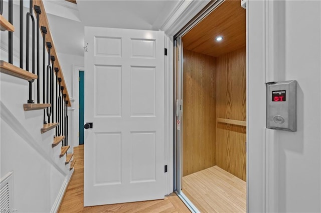 interior space featuring hardwood / wood-style flooring and elevator