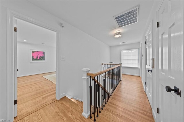 corridor with light hardwood / wood-style flooring