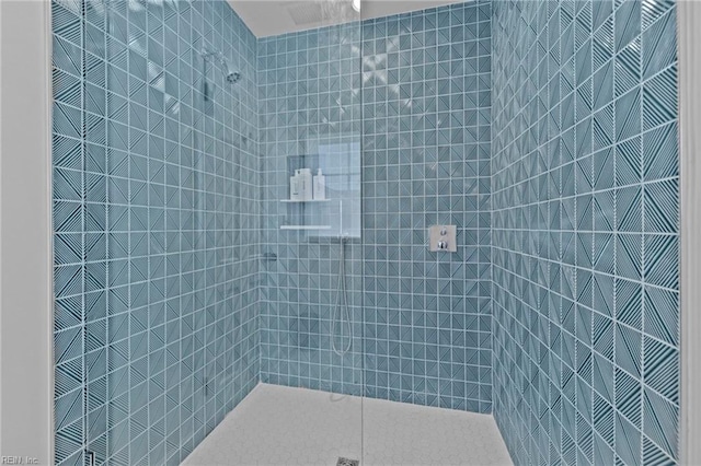 bathroom with tiled shower