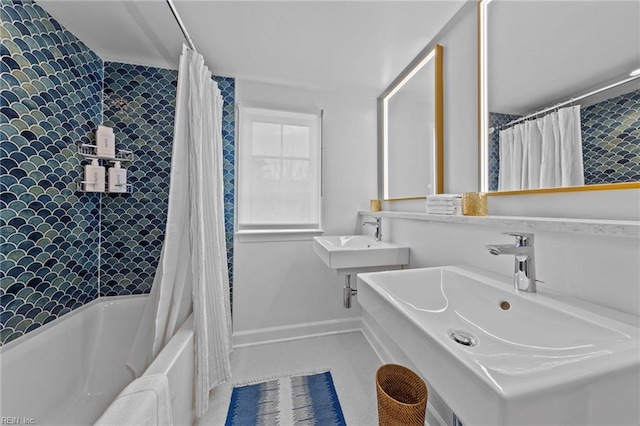 bathroom featuring shower / bath combo with shower curtain and sink