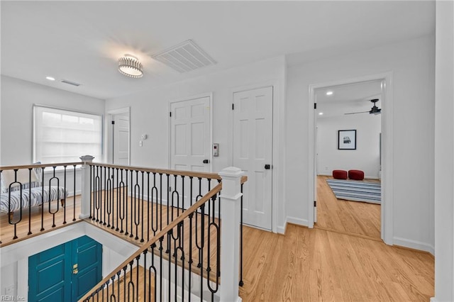 hallway with light hardwood / wood-style floors