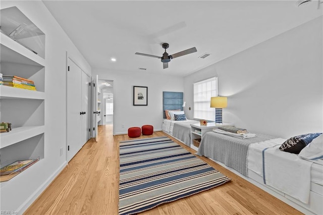 bedroom with hardwood / wood-style floors and ceiling fan