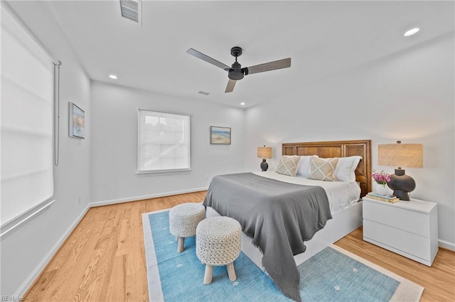 bedroom with light hardwood / wood-style floors and ceiling fan