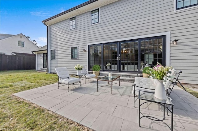 rear view of house with a yard and a patio